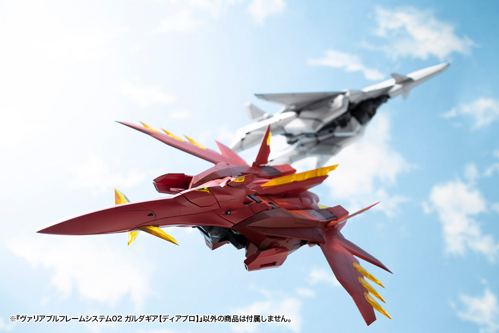 Red and yellow robot model with a gray fighter jet in the sky