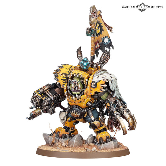 A painted Warhammer 40k Ork miniature on a white background, featuring a yellow and green goblin-like warrior with a white-haired dog on its back, wielding a large gun and carrying a flag.